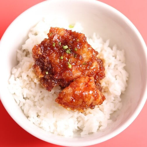 Smoked BBQ chicken thigh fillet on top of steamed rice.